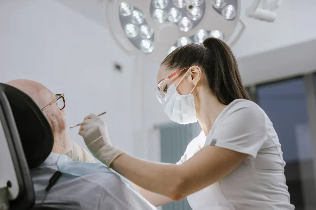 Dental professional examining a patient in a bright clinic