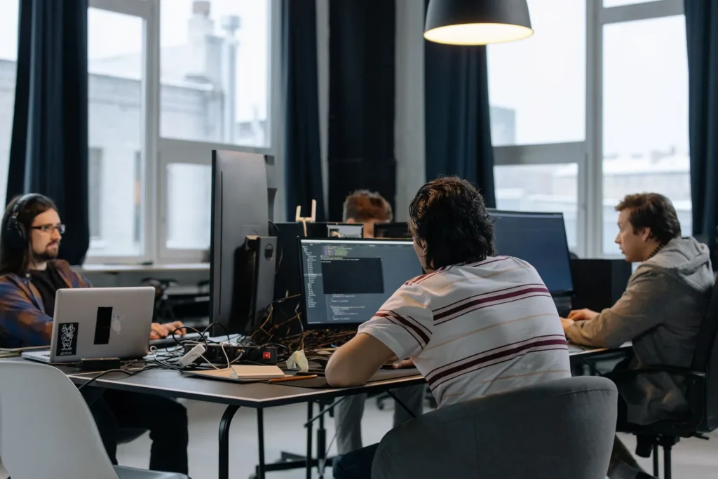 Colleagues working at computers in a bright open office