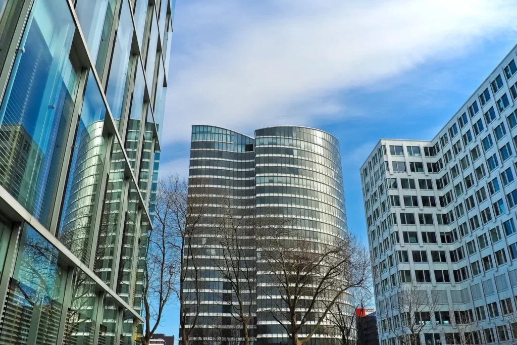 Modern glass office towers against a blue sky
