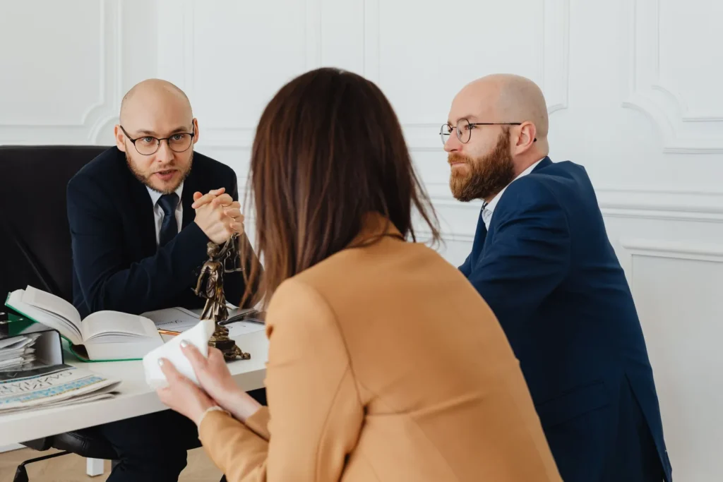 Lawyers consulting over documents in a bright office