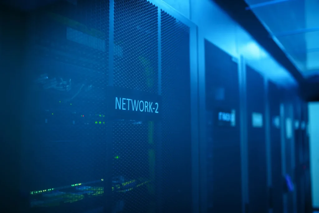 Blue-lit network room with racks of equipment