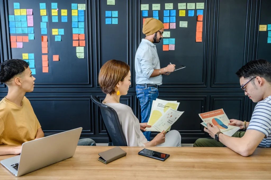 Team planning a project in front of a wall of sticky notes
