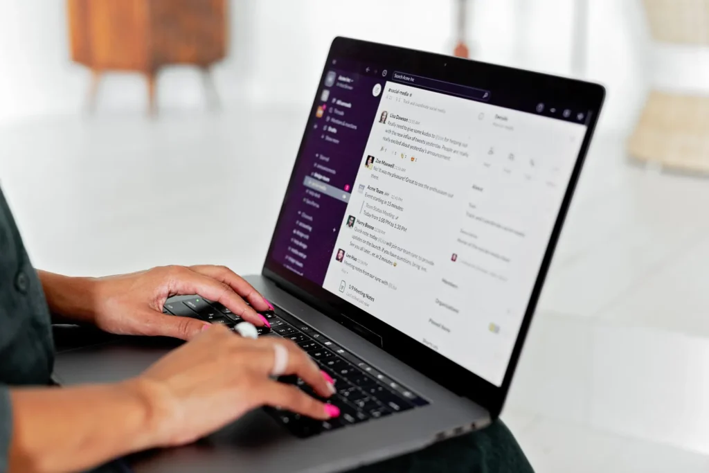 Hands typing on a laptop showing business software
