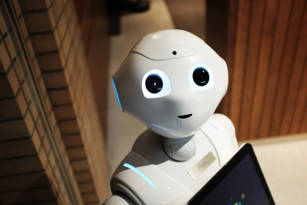 Friendly white robot holding a tablet